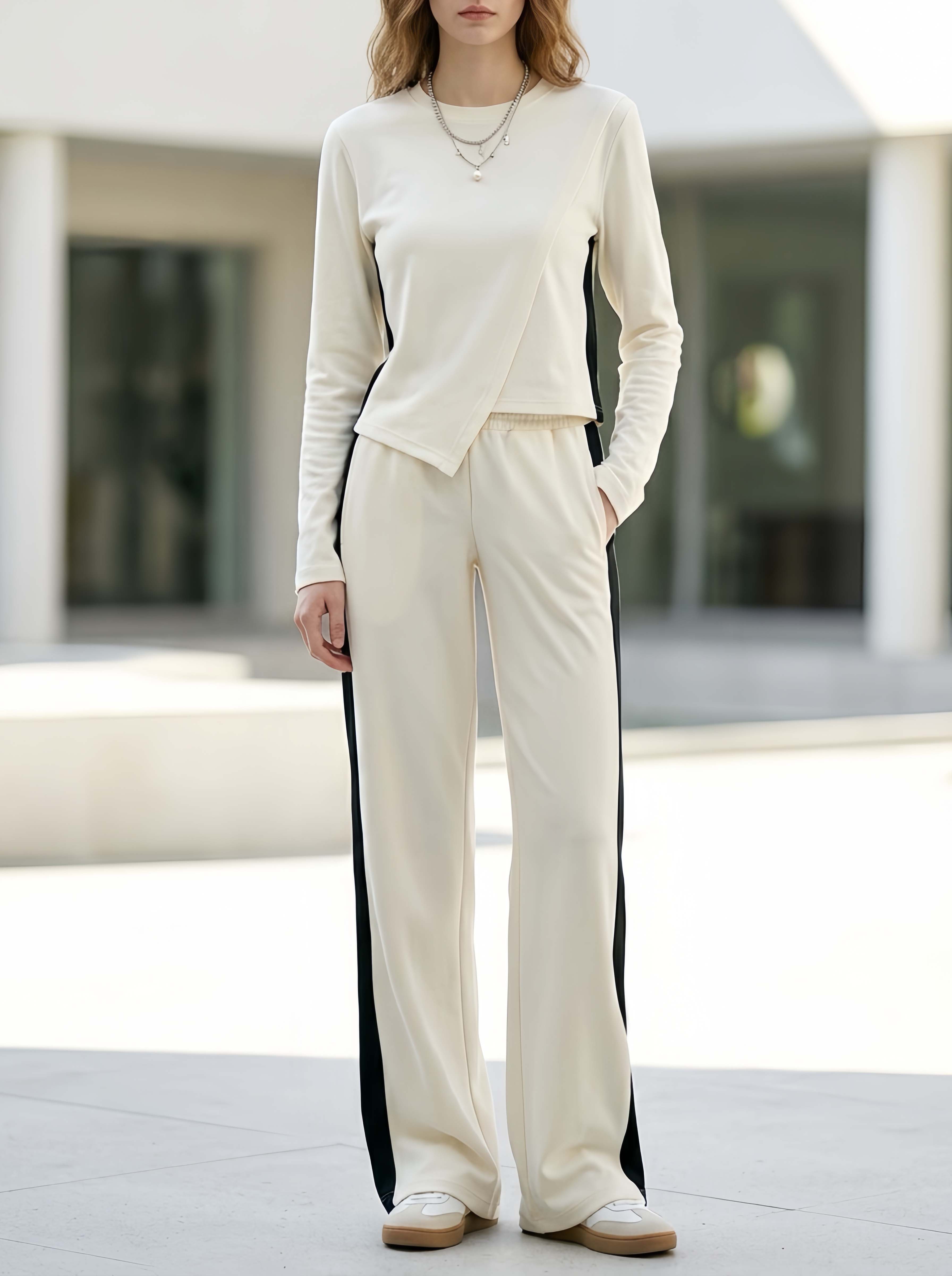 Minimalist White Long-sleeve Top With An Asymmetrical Hem And Color-block Trousers Set